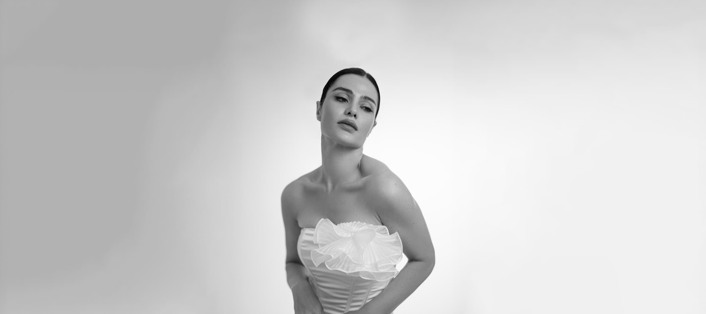 Portrait of a model in a white corset gown