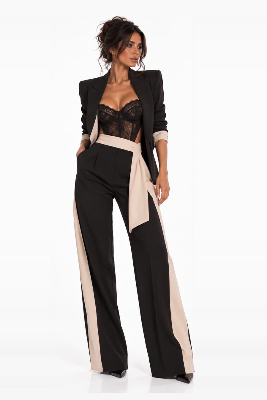 Black peak-lapel suit closed at the front by a champagne tie sash knotted at the waist